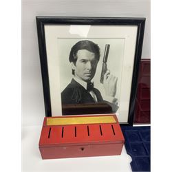 Pierce Brosnan framed picture, James Bond books, Corgi Tomorrow Never Dies BMW 750i model, small number of stamps, empty coin displays and other miscellaneous items