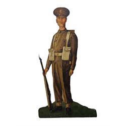 Military Outfitters hand painted life size wooden cut out figure of a WW1 soldier standing at ease holding a gun by his side, marked Stening Signs; hardboard on planked frame H199cm