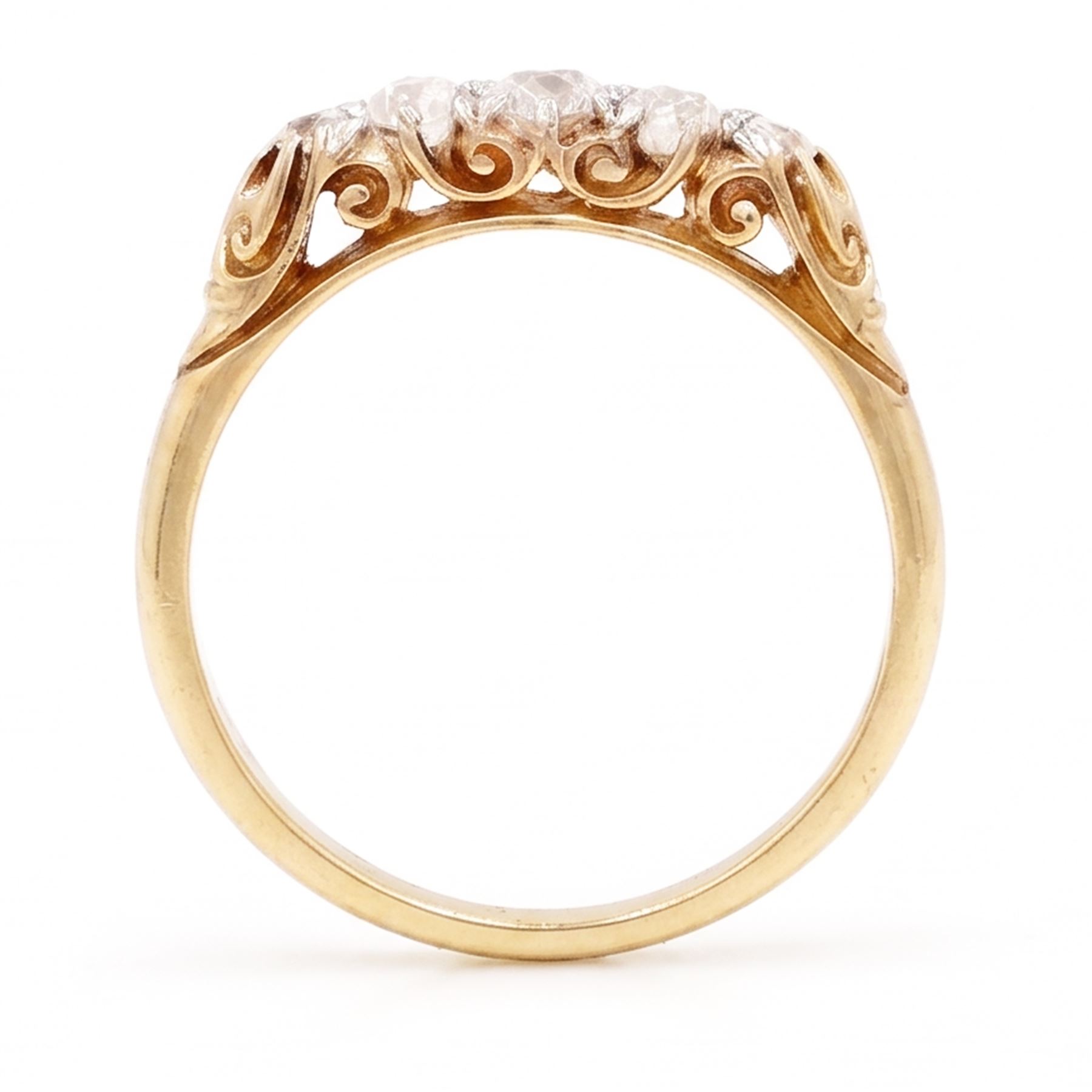 Early 20th century gold diamond ring, set with five graduating old cut diamonds, with scroll design gallery, stamped 18ct, total diamond weight approx 0.30 carat