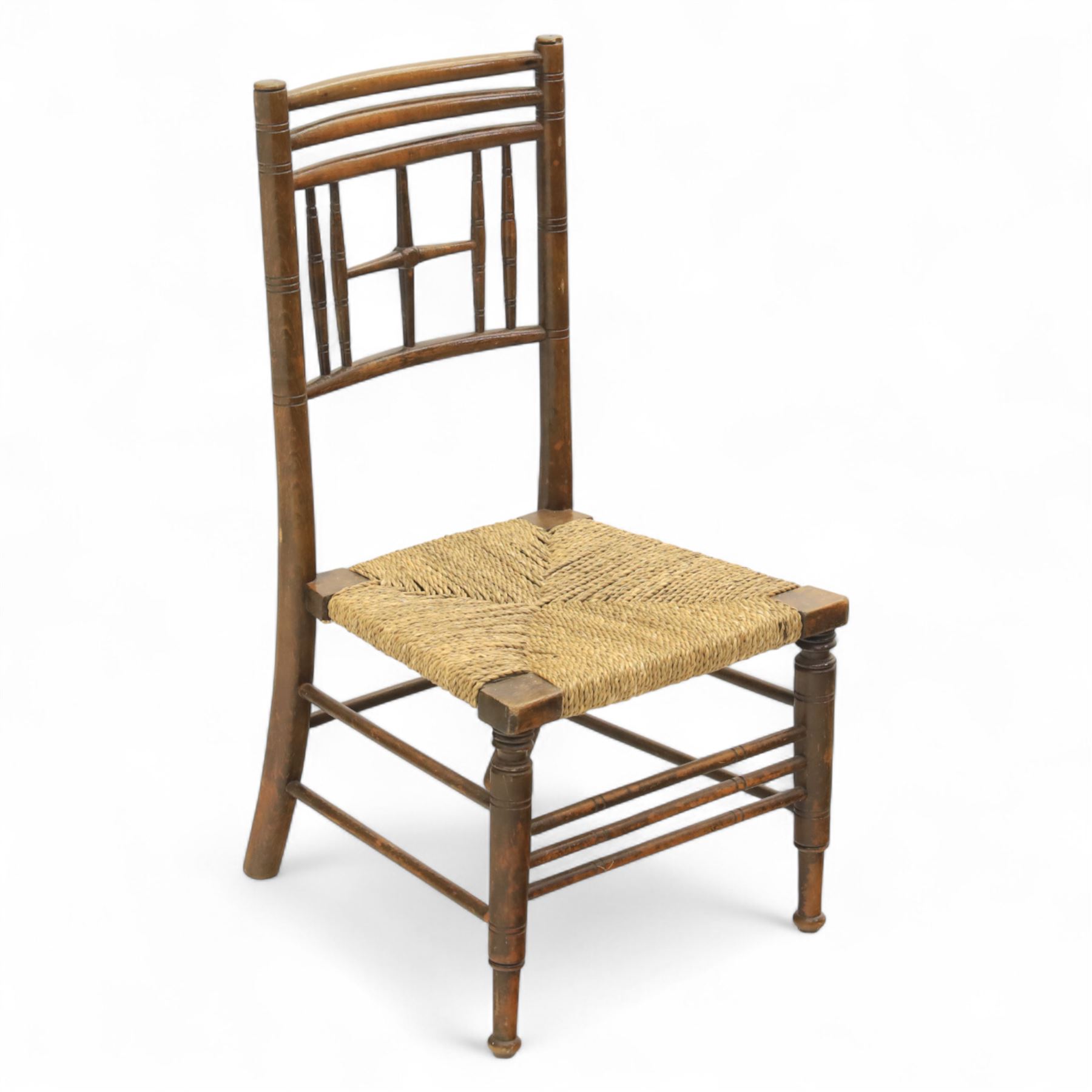 Ford Madox Brown, late 19th century Arts and Crafts child’s chair, with stained ash frame, triple curved top rails and turned spindle supports, the seat with woven rush, on turned legs united by front stretcher