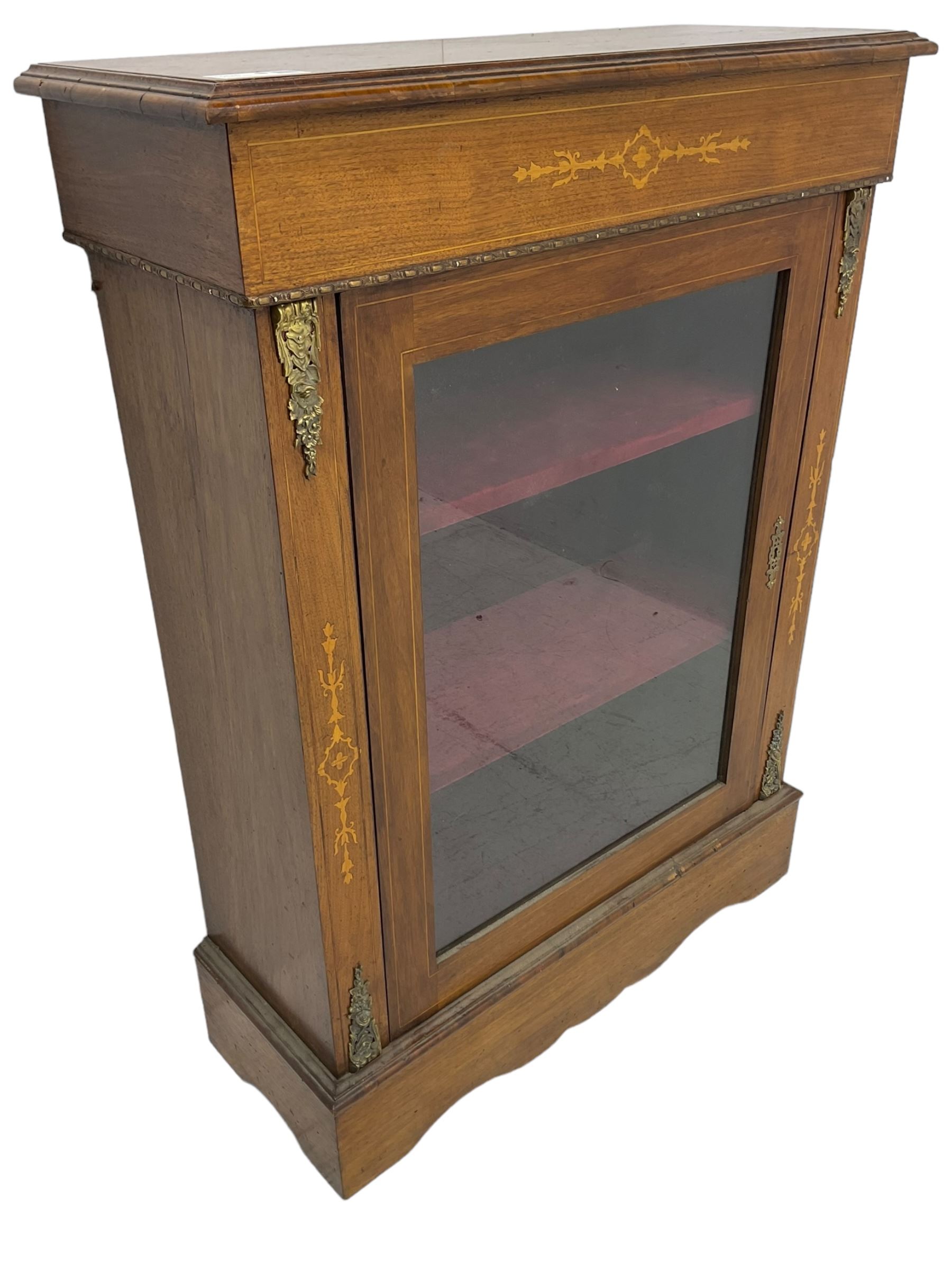 Victorian walnut pier cabinet, moulded rectangular top over inlaid frieze, enclosed by single glazed door, the uprights inlaid with extending stylised foliage decoration and cast gilt metal mounts, on moulded plinth base