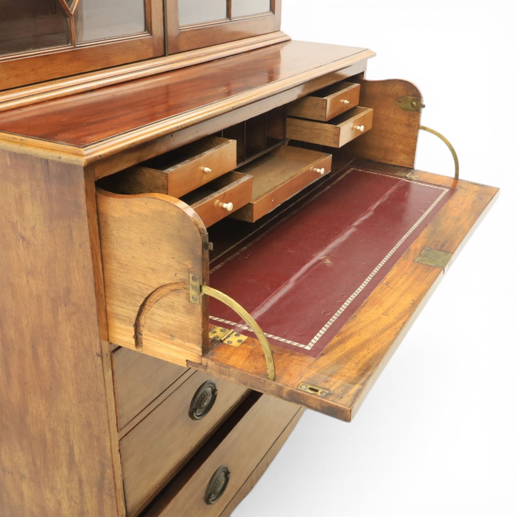 George III mahogany secretaire bookcase, the upper section with projecting cornice above astragal glazed doors, with three adjustable shelves, the lower section with secretaire drawer, fitted and with tooled leather writing surface, inlaid drawer fronts with brass handles, three graduating drawers below, raised on bracket feet