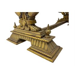 19th century Renaissance Revival carved and giltwood centre table, the rectangular top with gadrooned edge and carved frieze of repeating arched motifs with stylised scrolls, supported by a pair of carved winged griffin supports restrained by a central chained figure, on stepped rectangular bases united by carved stretcher