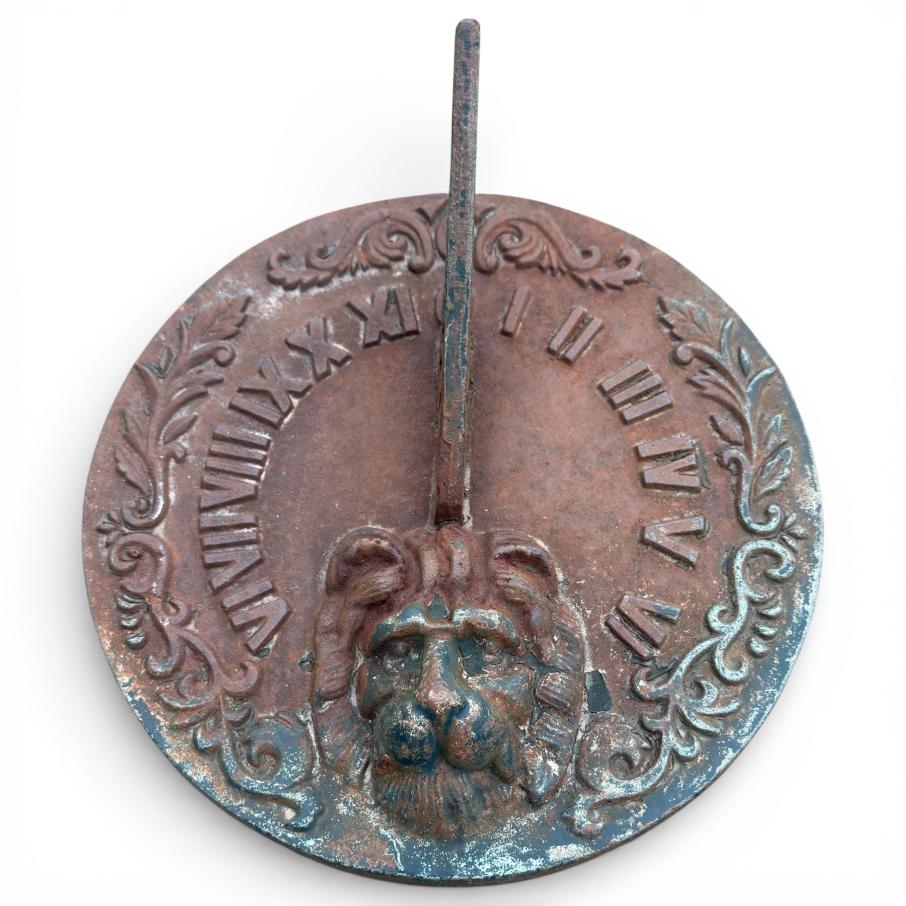 Cast stone garden sundial featuring a cast iron top with Roman numerals and lions head motif