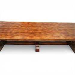 Country House 12' oak and fruitwood refectory dining table, the substantial rectangular plank top with cleated ends and chamfered edge, raised on twin trestle end square tapering and turned baluster supports with sledge feet and chamfered united by a long stretcher rail