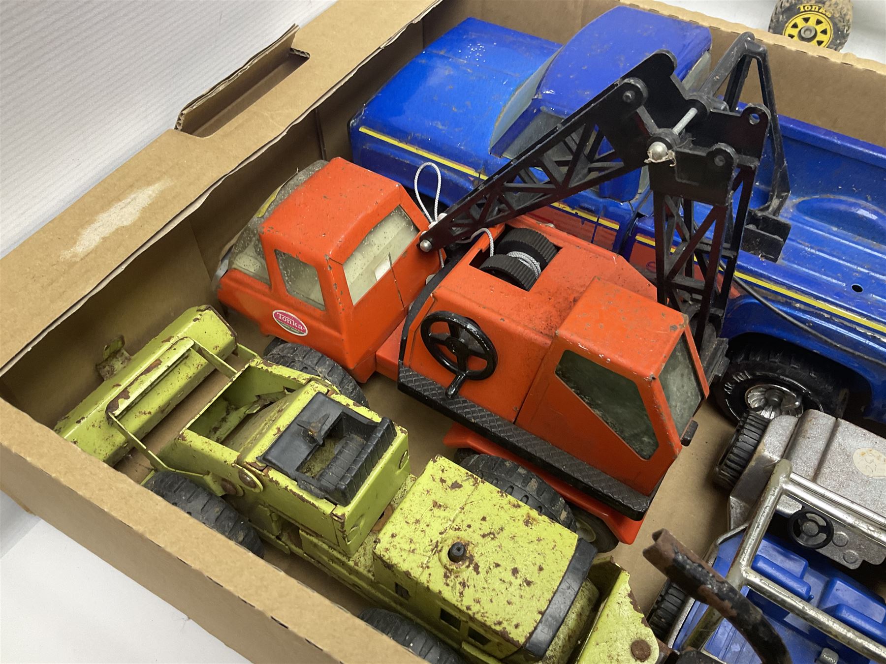 Tonka - fourteen pressed steel vehicles including Pick-up Truck, Tractor Digger, Mobile Crane, Trencher, Beach Buggy, two Bulldozers, Digger, Low Loader, Farm Trucks etc; and small quantity of spare parts (14)