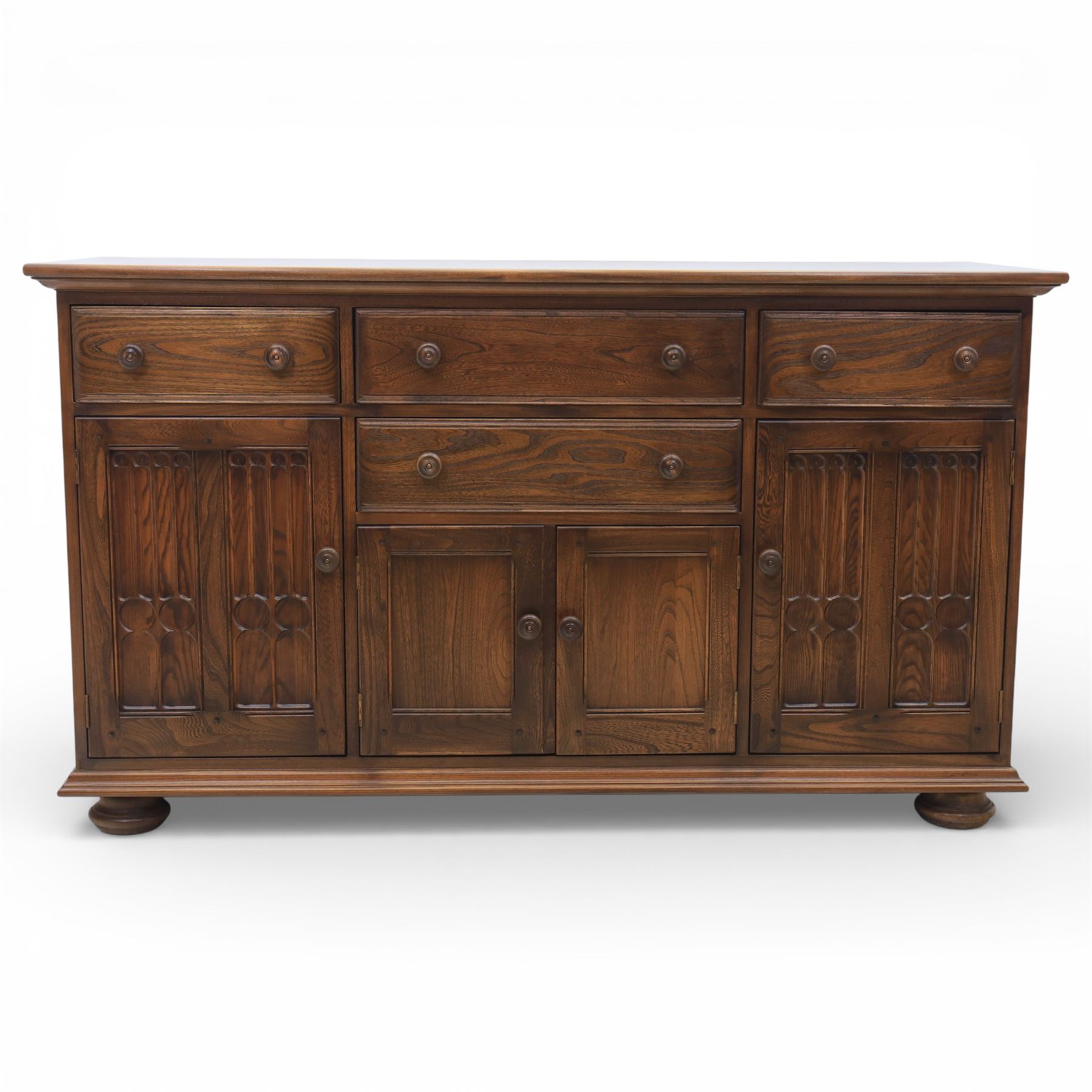 Ercol - elm dresser sideboard, fitted with four drawers and four cupboards with carved detail, drawer featuring cutlery slide