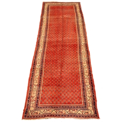  Araak red ground rug, field filled with boteh with a triple stripe geometric border, 315cm x 110cm  