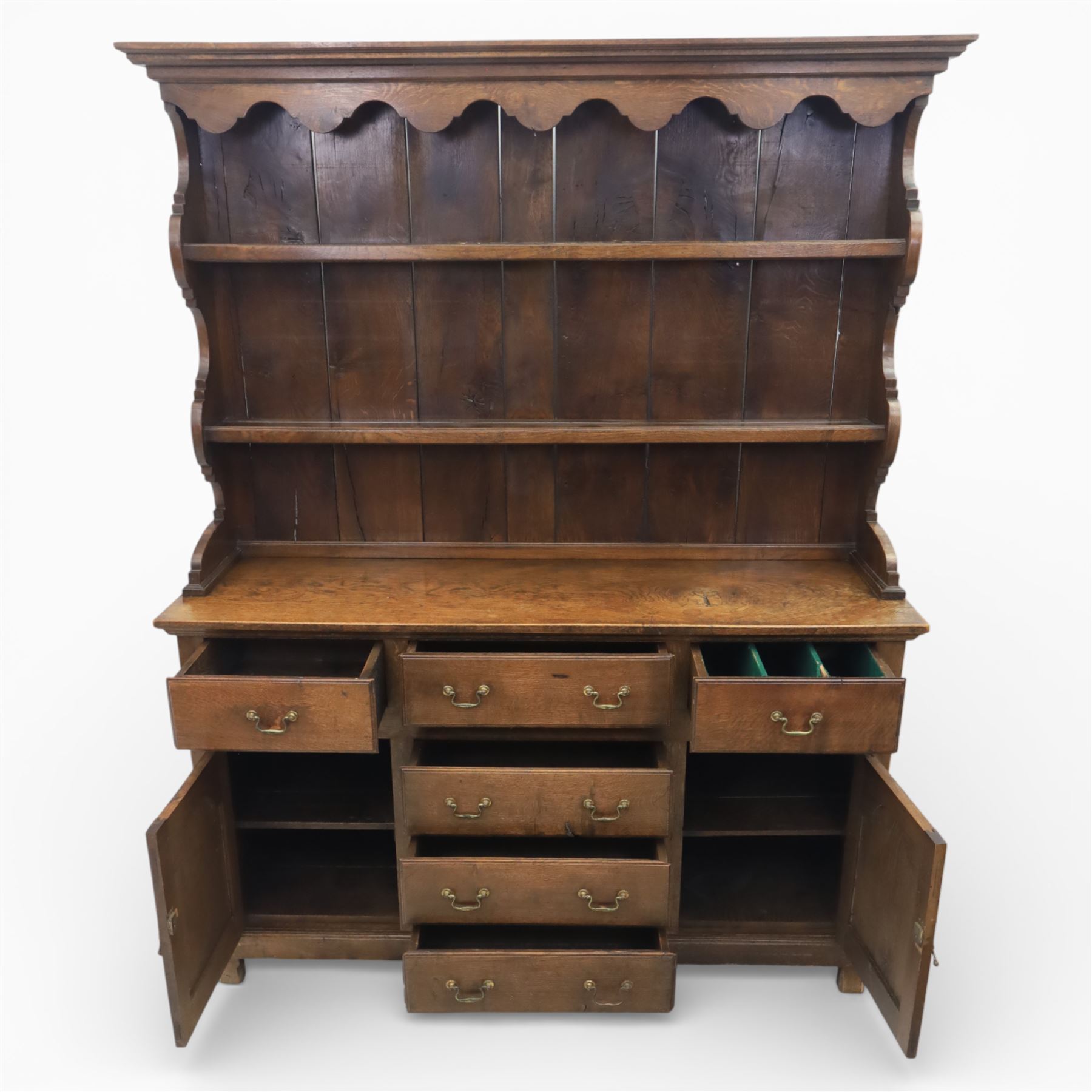 Georgian design oak dresser, the raised plate rack with shaped sides and two open shelves, upon a dresser base fitted with six drawers and two cupboard doors, and short block feet 