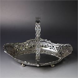 Early 20th century swing handled basket, of oval form with pierced sides and floral C scroll rim, upon four bun feet, hallmarked William Hutton & Sons Ltd, Sheffield 1915, widest point W29cm