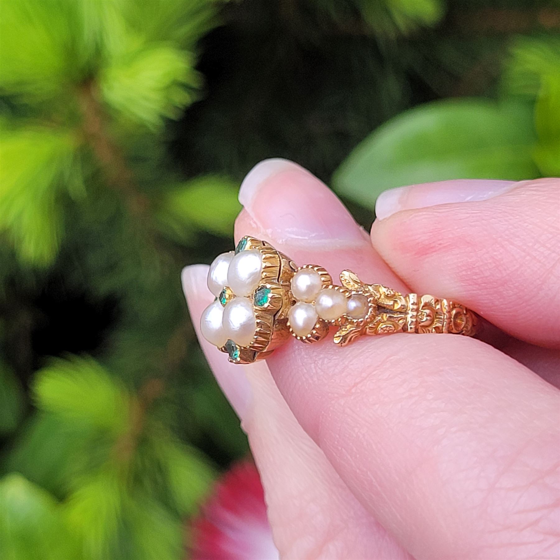 19th / early 20th century 18ct gold emerald and pearl flower head cluster ring, with pearl set shoulders and engraved foliate shank