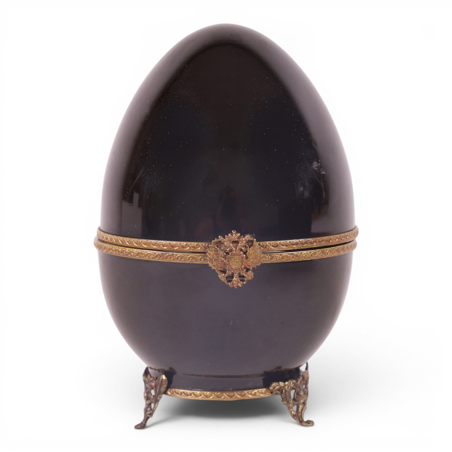 Limoges Fabergé  'Movie Camera' egg, the black and gilt hinged lid opening to reveal a gilt interior with a film camera to the center, with certificate and box, H14cm