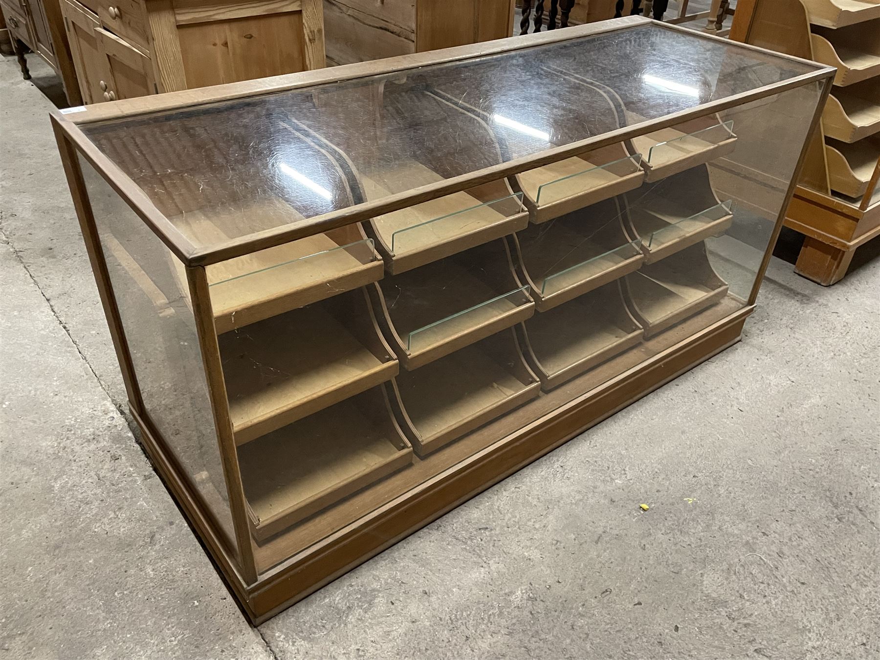 20th century oak and glazed haberdashery shop's display cabinet, fitted with twelve slides, on skirted base - THIS LOT IS TO BE COLLECTED BY APPOINTMENT FROM THE OLD BUFFER DEPOT, MELBOURNE PLACE, SOWERBY, THIRSK, YO7 1QY