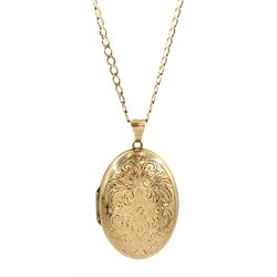 Gold locket pendant necklace, with engraved foliate decoration, on gold flattened curb link chain necklace, both 9ct