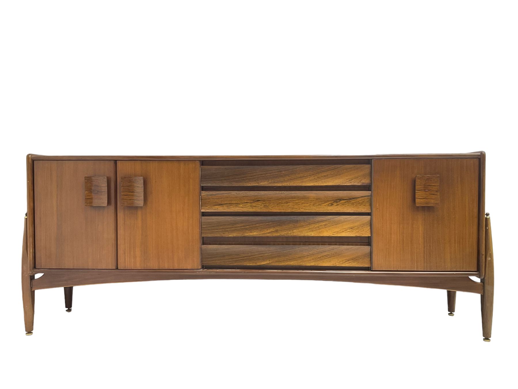 Elliots of Newbury (EoN) - mid-20th century teak sideboard, fitted with four central doors flanked by fall-front cupboard and a double cupboard, each with concave wooden handles