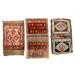 Antique Persian red ground saddle bag, decorated with all-over Boteh motifs, geometric patterned border (127cm x 68cm); Persian indigo ground saddle bag, decorated with two geometric ivory lozenges (113cm x 62cm); Persian red ground saddle bag decorated with lozenges and multi-band border (110cm x 65cm) 