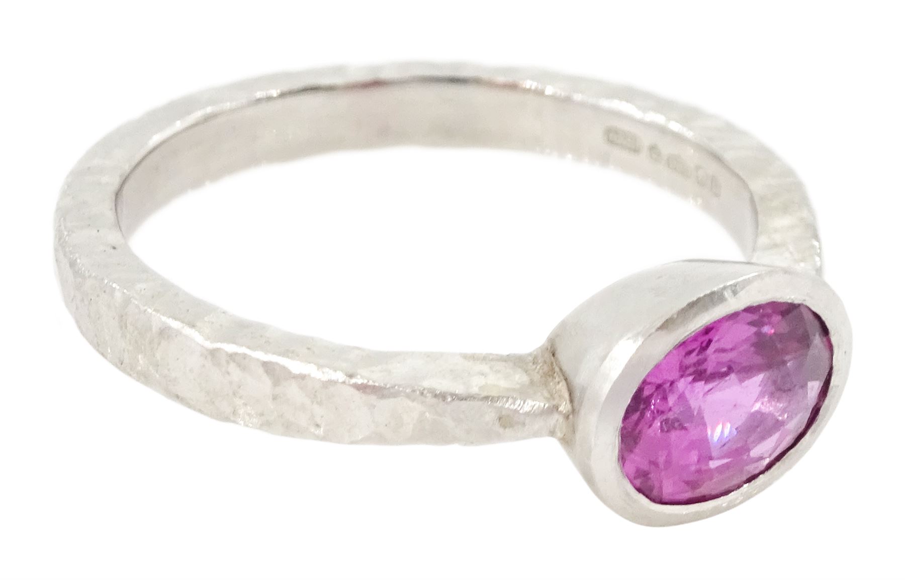 Platinum pink sapphire ring, single bezel set sapphire of approx 1.40 carat, to a planished shank, London 2019