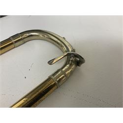 Three brass trombones comprising Elkhart Ind. USA 'CONN' model no.72H; Besson 'Concord'; and Selmer Distributed 'Lincoln'; two in carrying cases; and German B & M 'Champion' brass trumpet (4)