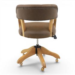 Captain's swivel desk chair upholstered in buttoned tan leather, button backed chair rail, padded and downswept arms, raised on a six point base with castors