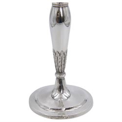 Pair of continental silver candlesticks, probably German Hanau, each of tapering form, with fern leaf decoration, upon a stepped circular base, with Hanau marks and assay scrape to base, H19cm