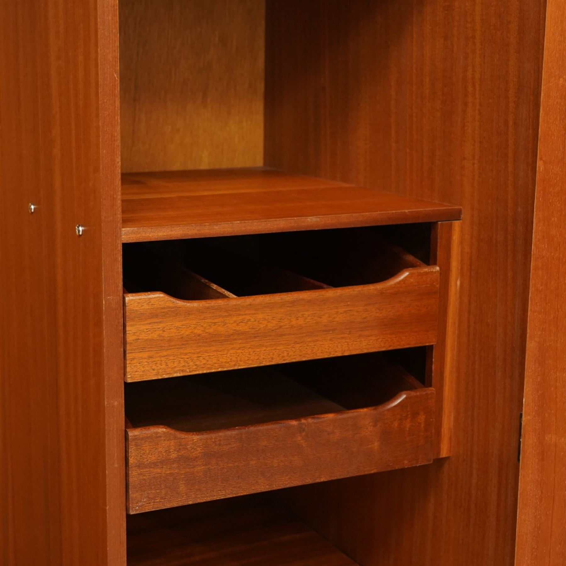 G Plan - 'Fresco' teak double fitted gentleman's wardrobe, twin doors enclosing two sections, a single clothes rail and drawers and shelving, on a recessed plinth base