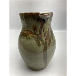 Michael Leach (British 1913-1985) for Yelland pottery; two large glazed stoneware plates with dark brown stylised decoration upon oatmeal ground, together with a jug in merging blue, green and brown, all with impressed marks beneath, largest plate D37cm