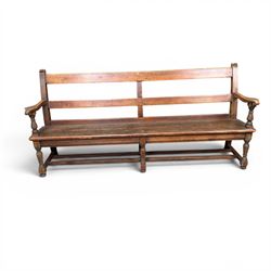 Early 20th century pine and oak bench seat, stained pine rail back frame with shaped oak arms