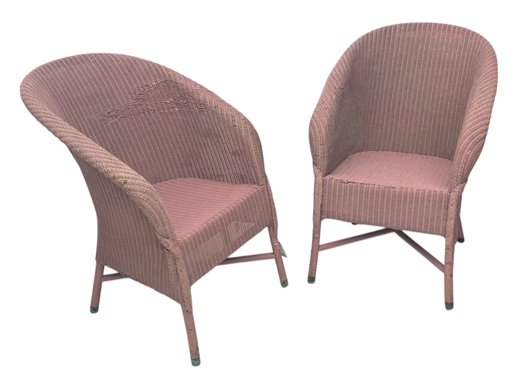 Pair of Lloyd Loom design tub chairs, each with woven wicker construction, curved backrests and painted in a soft pink finish, on cylindrical supports with X-stretchers