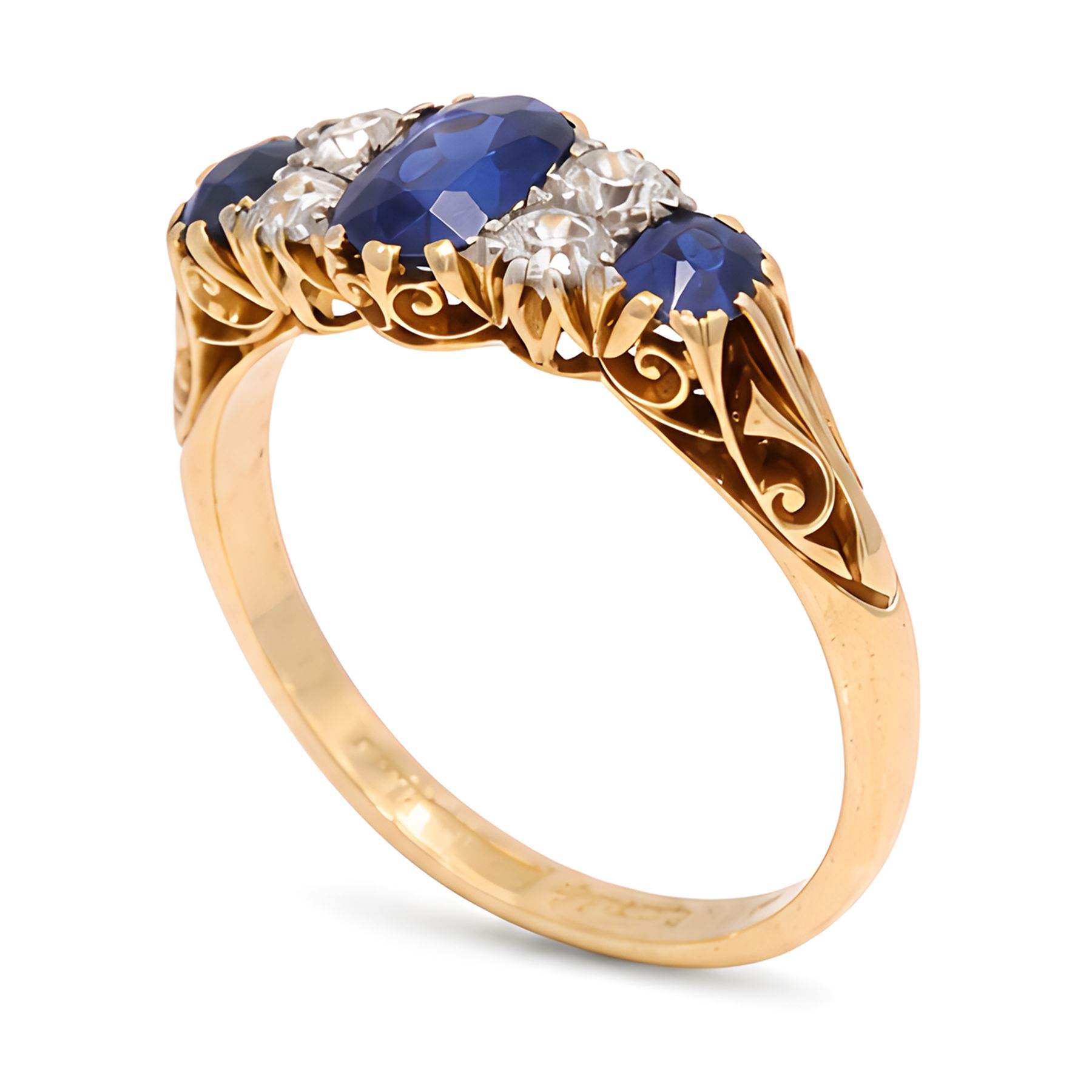 Early 20th century gold sapphire and diamond ring, three vari-cut sapphires, spaced by four old cut diamonds, with scroll design shoulders, stamped 18ct, total sapphire weight approx 1.45 carat, total diamond weight approx 0.30 carat