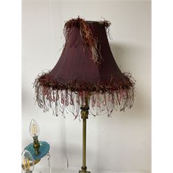 Brass table lamp, modelled as a candelabra with five branches, each with blue glass candle holders with crystal drops, H47cm, together with a pair of cast metal table lamps with acanthus leaf detail, upon a stepped square base, with red fabric feather and tassel shades, H78cm