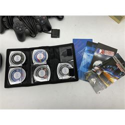 Sony PlayStation 3 60GB console with one PS3 controller, two PS2 controllers, BD remote control, PSP handheld gaming console with case, GAMEware PSP essentials pack, and a selection of PS2, PS3 and PSP games in original cases with instruction booklets 