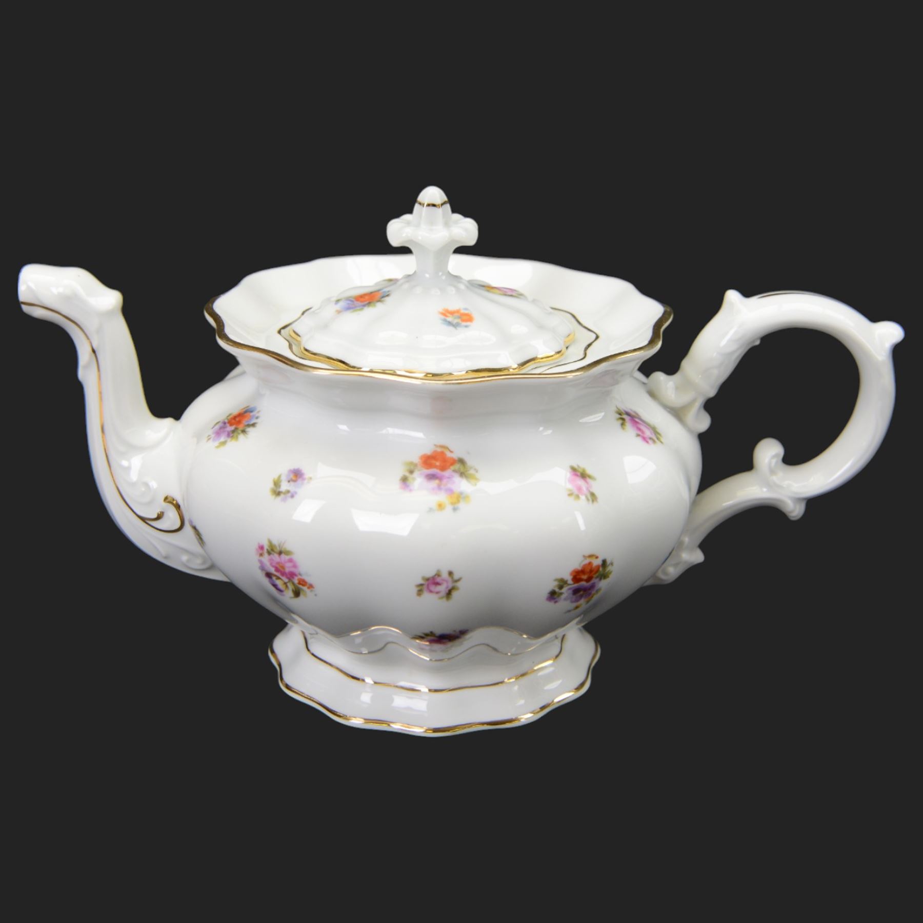 Forstenberg part tea and dinner service, comprising teapot, teacups and saucers, dinner plates, tureens, sauce boat, lidded sugar bowl, side plates and serving plates, all decorated with polychrome floral sprigs on a white ground with gilt edging
