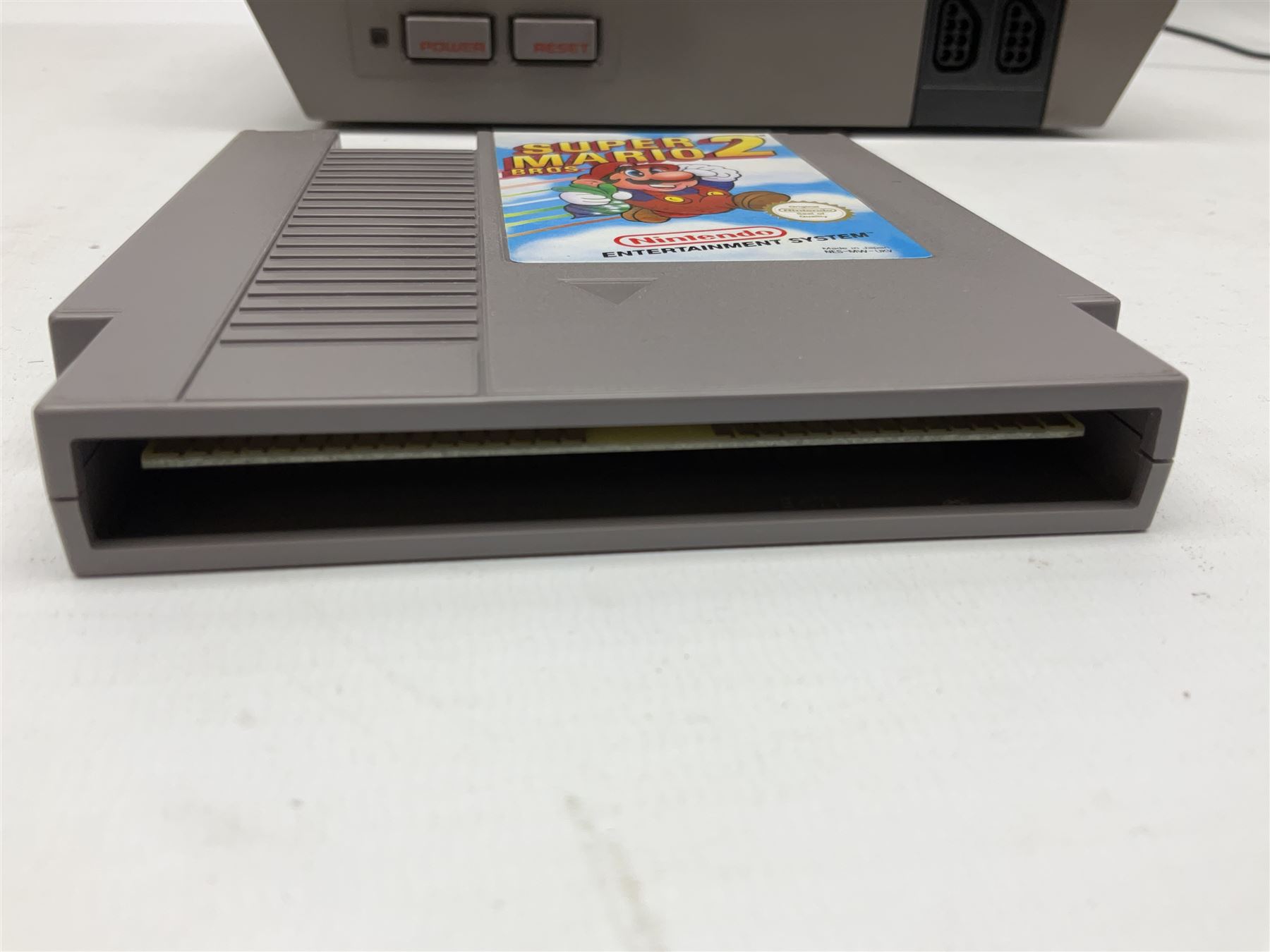 Nintendo Entertainment System (1985) console with two controllers, accessories and instruction booklet. NES Games ‘Duck Hunt’ with Nintendo Zapper gun, ‘Pinball’ and ‘Super Mario Bros.’, all with original sleeves and instruction booklets. NES game ‘Super Mario Bros. 2’ cartridge only