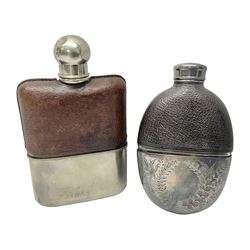 Silver plated glass and pressed leather hip flask, with swivel cap and removable cup, together with a similar oval example, engraved with wreath and initial B, tallest H16.5cm