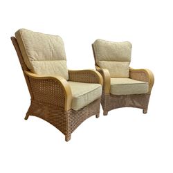 Contemporary rattan conservatory suite - two seat sofa with wicker frame and loose cushions upholstered in textured champagne fabric (W125cm H98cm); pair of matching armchairs (W72cm H98cm); rectangular glass-topped coffee table with rattan frame and undertier (W85cm D60cm H47cm); and matching square side table (W53cm H55cm)