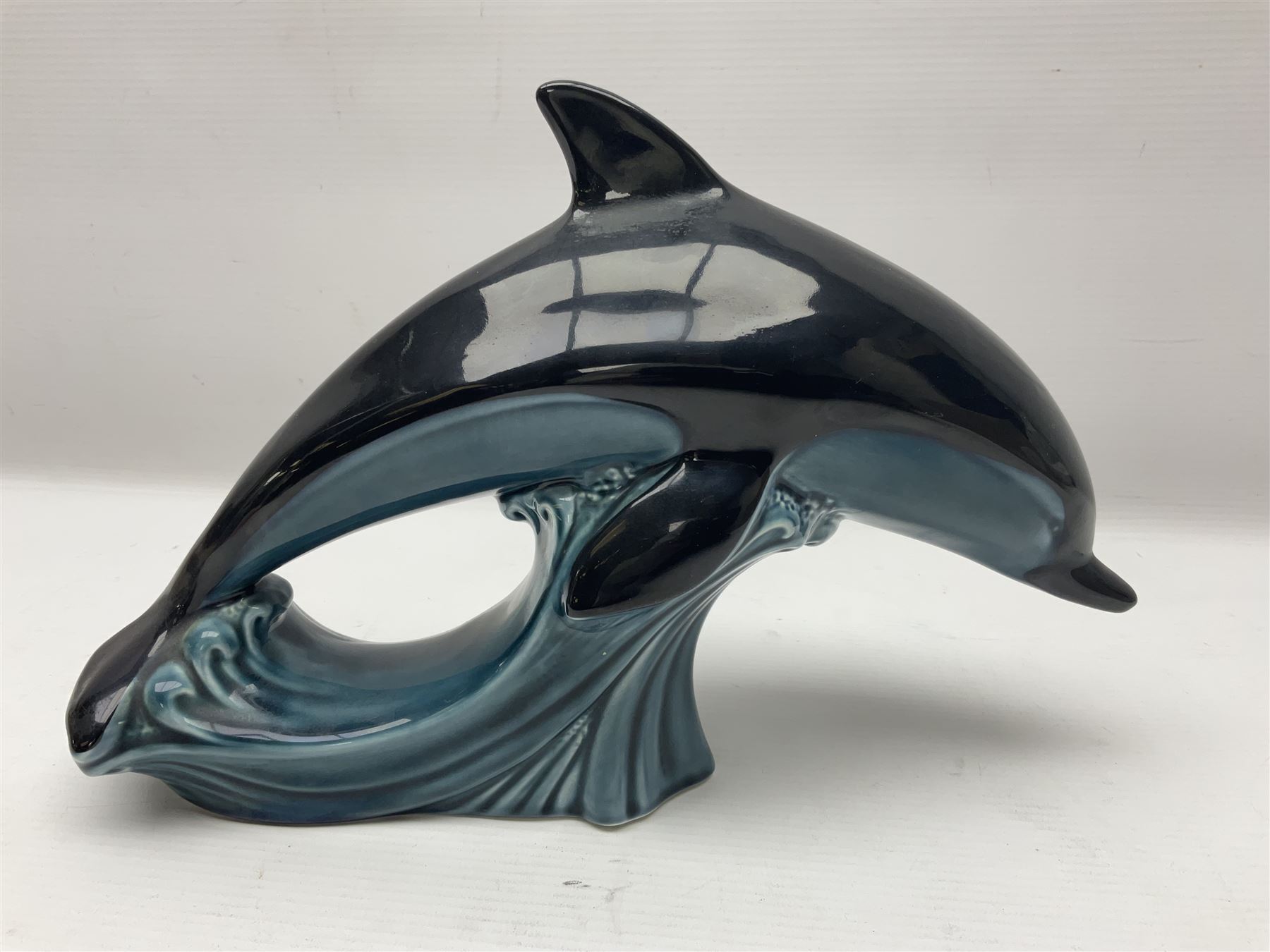 Poole pottery Dolphin, together with Royal Worcester miniature teacup and saucer, Royal Crown Derby miniature teacup and saucer in Derby Posies and one other