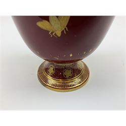 1886 Royal Crown Derby twin handled urn, decorated with gilt swags, fruit and insects on a red ground, H19cm 
