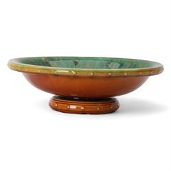 Christopher Dresser for Linthorpe; pedestal bowl, glazed brown to the exterior, the interior in blues and greens, with impressed mark 451 beneath, H8cm, D25cm