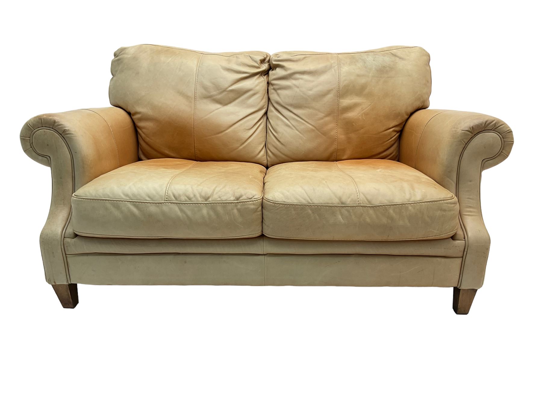 Two seat sofa, upholstered in pale tan leather with scrolled arms ...