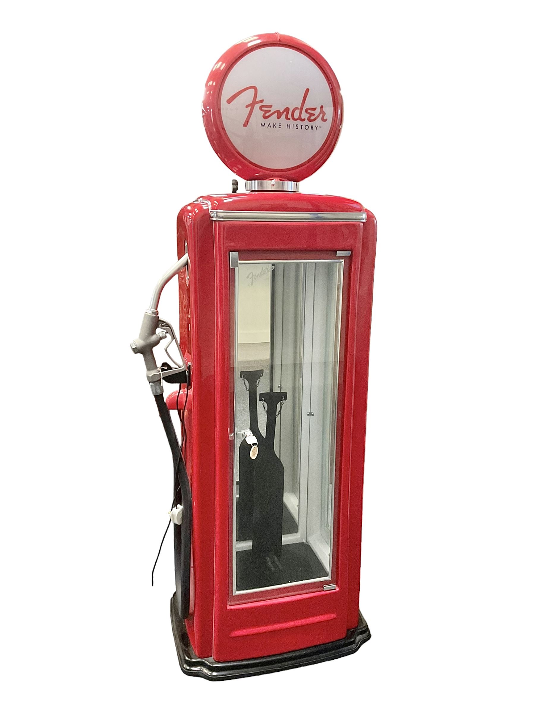 Roadside Relics Fender Custom Shop guitar display case, modelled as an American petrol pump, with a circular two-tone Fender logo light upon the pillar box red cabinet, three sides with glazed panels and chrome detailing, one etched with Fender logo, the interior with removable guitar stand, height including light 184cm