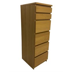 IKEA light oak finish chest, fitted with hinged vanity top, above six graduating drawers 