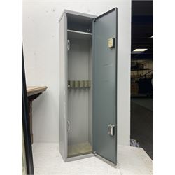 Two-tone grey steel wall-mounting gun cabinet by Sambell Engineering to accommodate six guns with fixed shelf over, gun space int. H132cm W36.5cm D23.5cm, the single double-locking door with two sets of keys, ext. H154cm W37cm D27cm