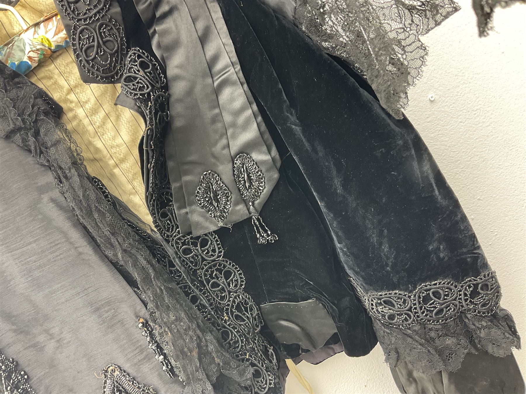 Victorian three piece mourning dress, with lace trim and jet beading, including velvet coat with satin collar panels and cuffs, the nipped waist with boning and slight flared peplum, heavily embellished beaded high neck collar, and ladies embroidered silk lined purse with gilt handle, mount and clasp