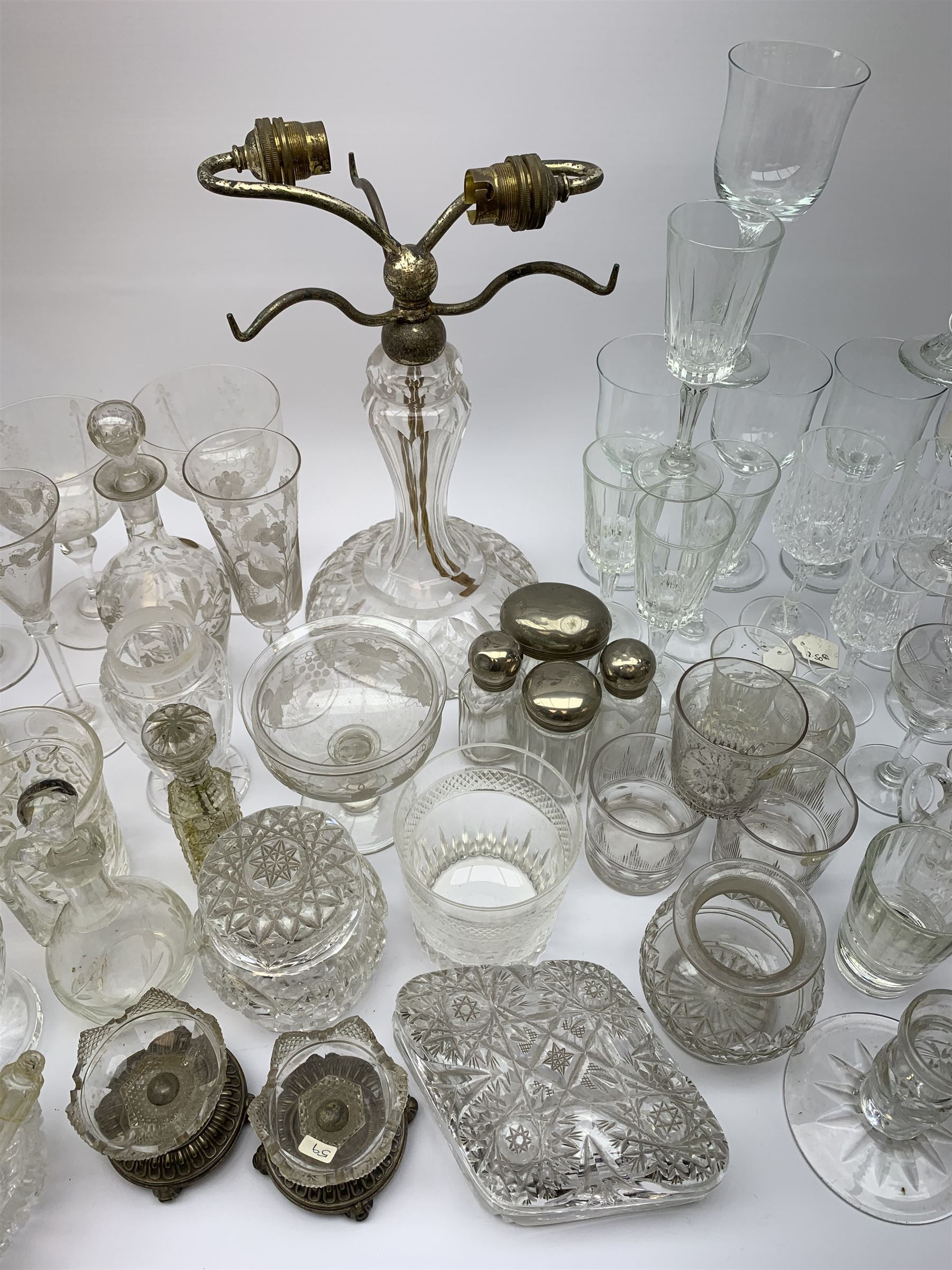 A number of Victorian tumblers and Edwardian drinking glasses, together with a large quantity of other later glassware, to include a glass table lamp base, drinking glasses of various forms, a number with cut decoration, other assorted cut glass including jug, vases, jars and covers, etc. 