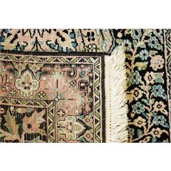 Persian style rug, central floral medallion surrounded by intricate palmetters, vines and rosettes, navy blue ground with ivory and pink highlights