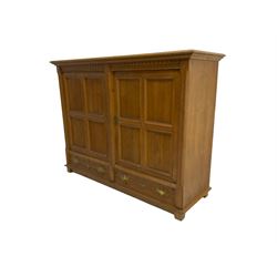 Continental 20th century carved oak cabinet, dentil frieze over two panelled doors with fluted facias, over two drawers