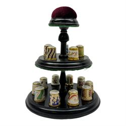 Collection of fifteen Royal Crown Derby thimbles upon an ebonised display stand, together with Royal Crown Derby candle snuffer in Imari pattern 1128