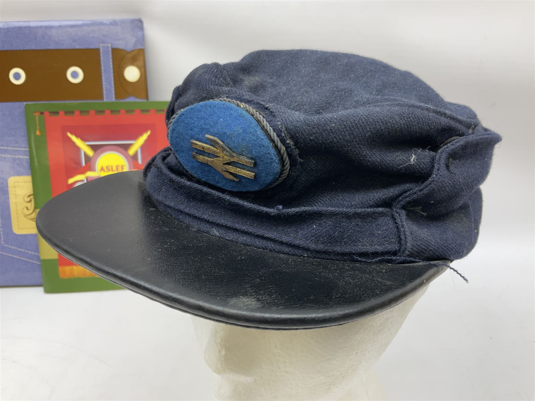 Black painted three colour railway lamp with revolving filters, H29cm; BR Acme Thunderer whistle; three railway peaked caps, two with BR Intercity 125 badge; small album of photographs of railway interest etc