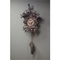 Early 20th century Black Forest style cuckoo clock, with cockrill pediment, carved with flower heads and foliage, H56cm   