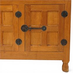 Lizardman - oak 5' sideboard, rectangular top over three panelled frieze drawers, fitted with two double panelled cupboards with wrought iron handles and locks, raised on tapered octagonal feet, with carved lizard signature, by Derek Slater of Crayke